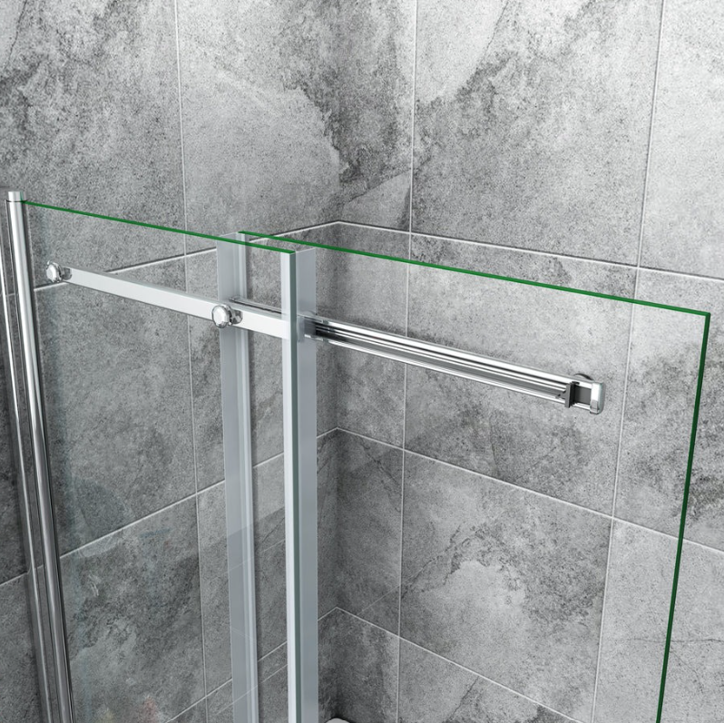 Top support bar and hinge detail of chrome pivot sliding bath shower screen with clear glass panels installed on grey tiled wall
