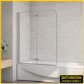 Curved glass bath shower screen with chrome frame fitted on modern bath with tiled walls