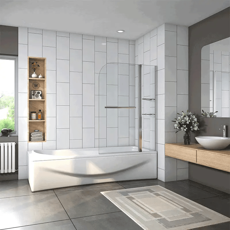 Chrome bath shower screen with glass panel in modern bathroom with tiled walls