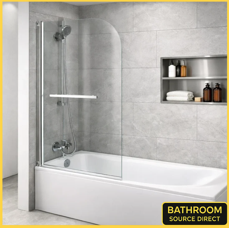 Chrome pivot bath shower screen with curved glass panel fitted on a white bathtub in a modern grey tiled bathroom with recessed shelf