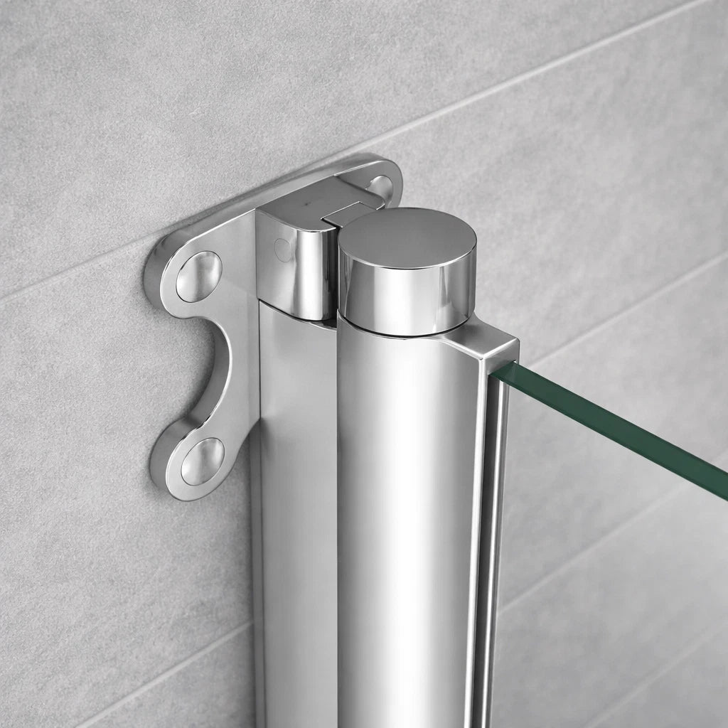 Close-up of chrome pivot bath shower screen hinge and wall fixing bracket showing glass panel connection and polished finish