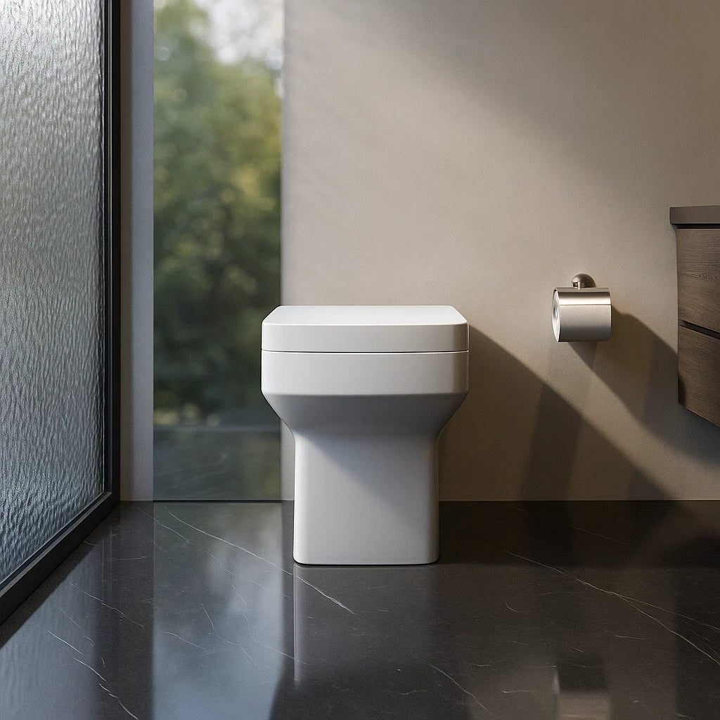 Modern white toilet in a bathroom with a glass door