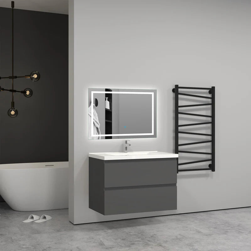 Bathroom setup with a vanity, mirror, and towel warmer against a gray wall.