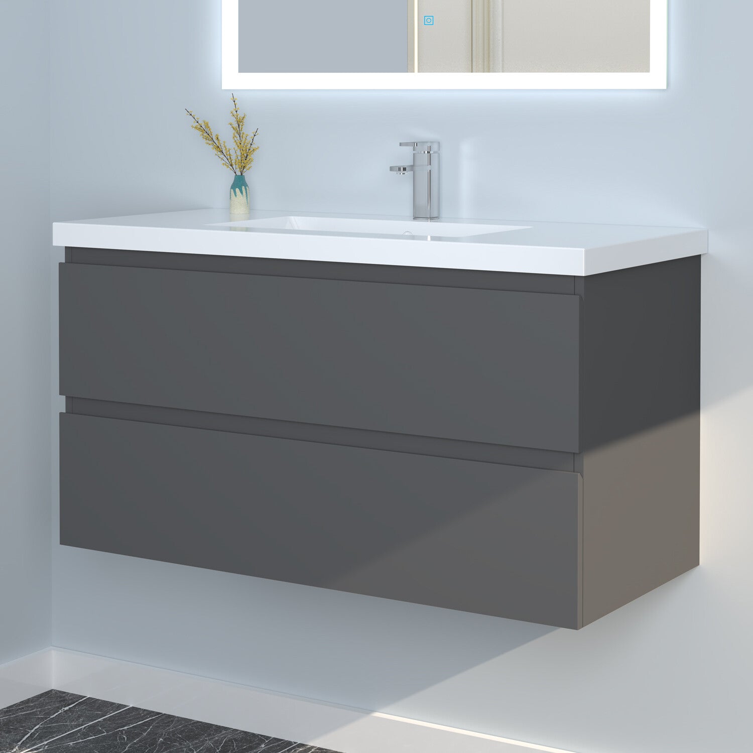 Bathroom vanity with white countertop and gray base cabinet, featuring a mirror above.