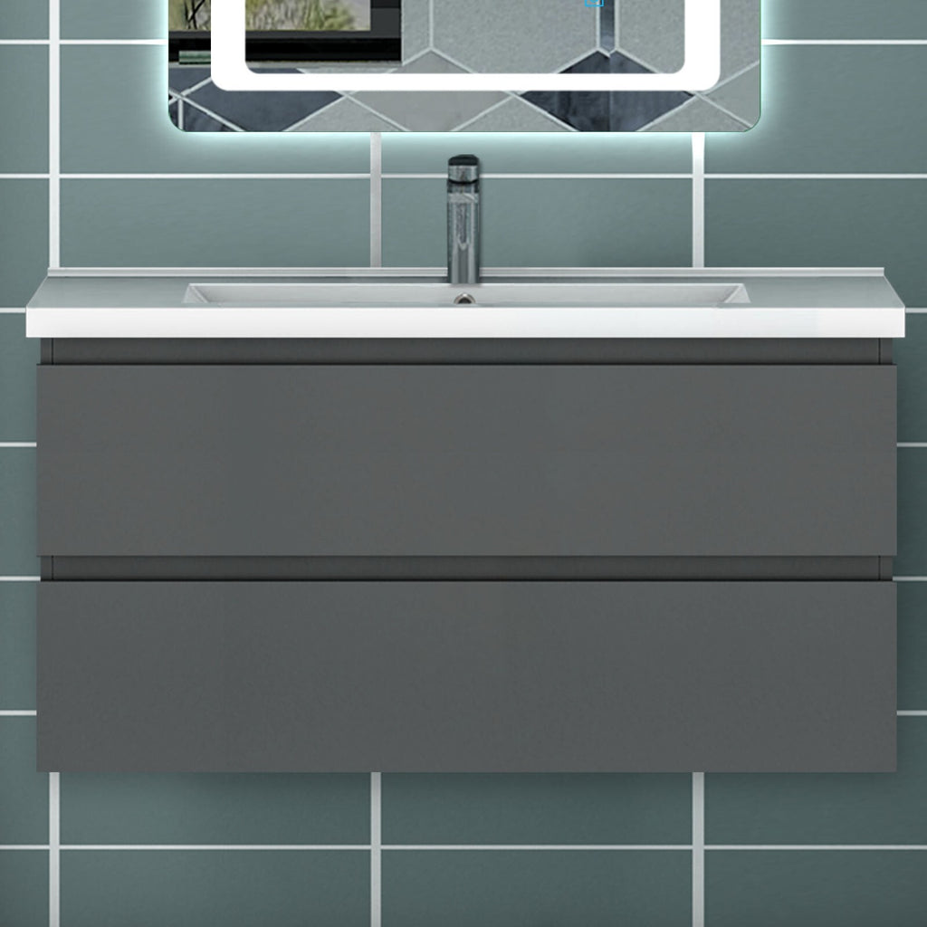 Grey wall hung vanity unit with integrated basin front view under LED mirror in tiled bathroom