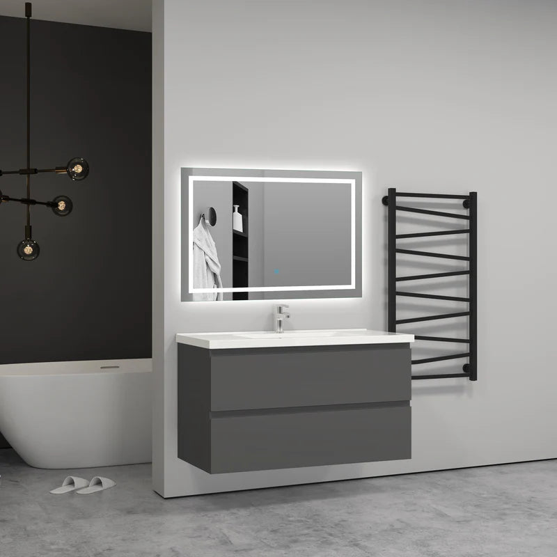 Grey wall hung vanity unit with LED mirror, bath and towel rail in modern bathroom setting