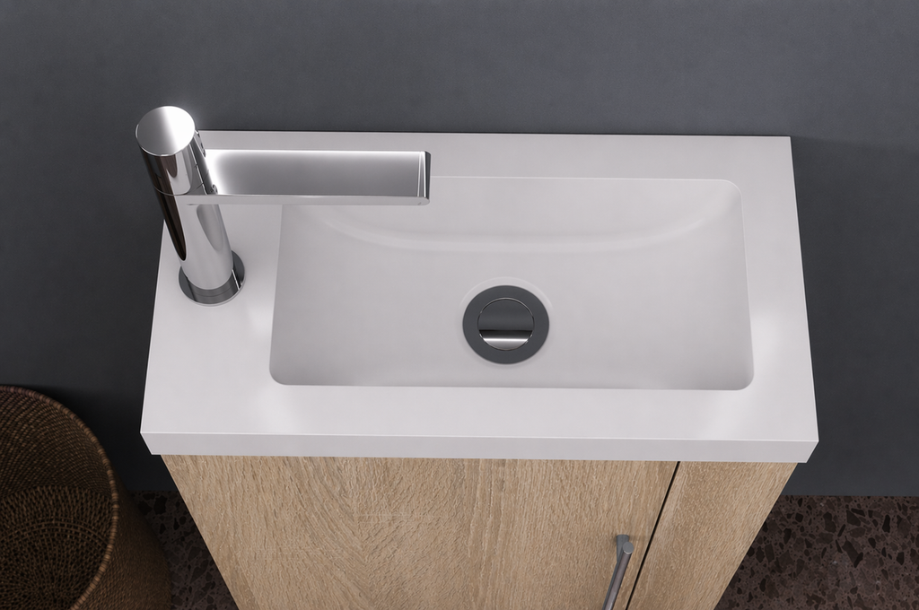 Modern bathroom sink with wooden oakcabinet and chrome faucet against a gray wall.