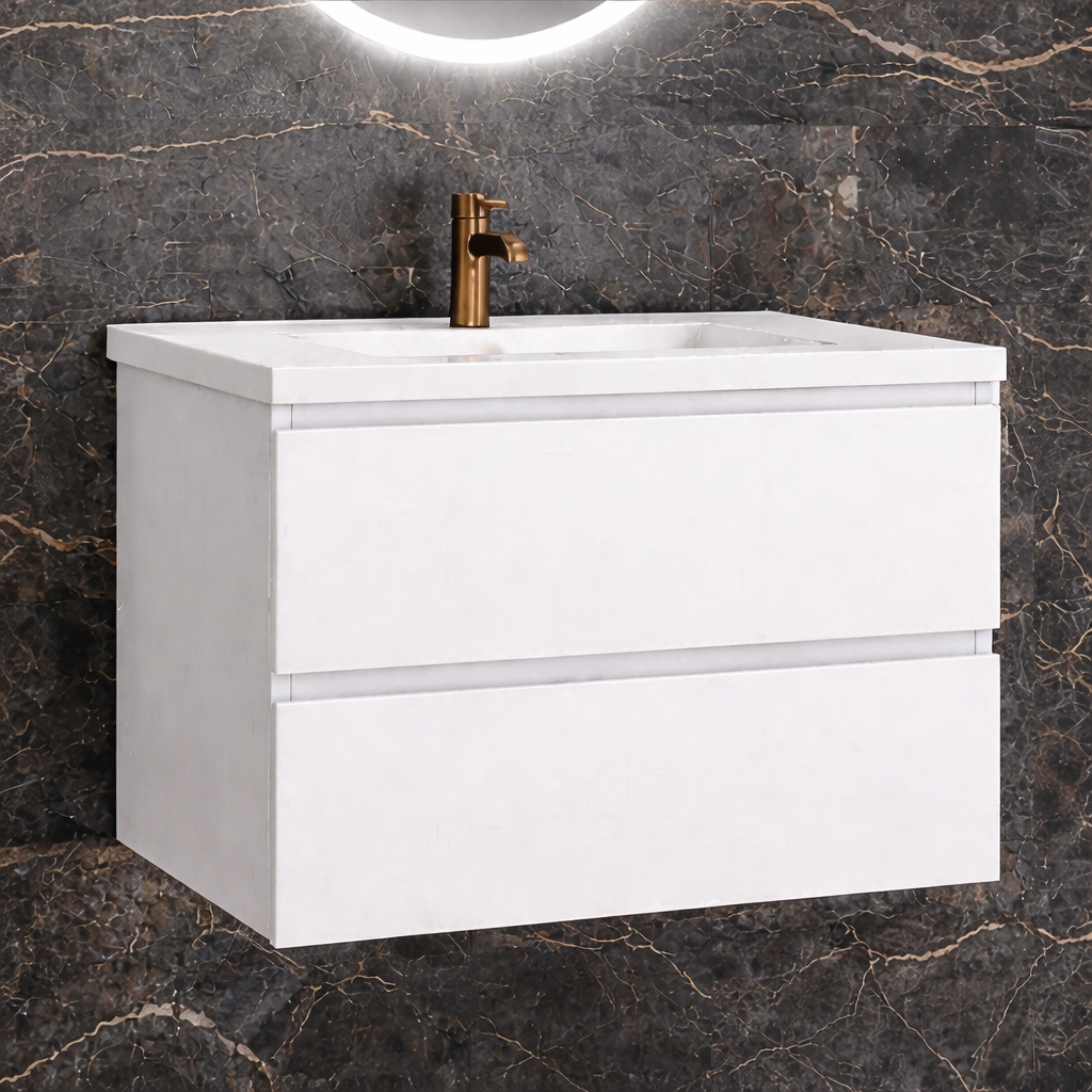 White wall hung vanity unit in dark marble bathroom setting with brass tap and round mirror