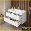 White bathroom vanity with open drawers in a bathroom setting, featuring 'Bathroom Source Direct' branding.