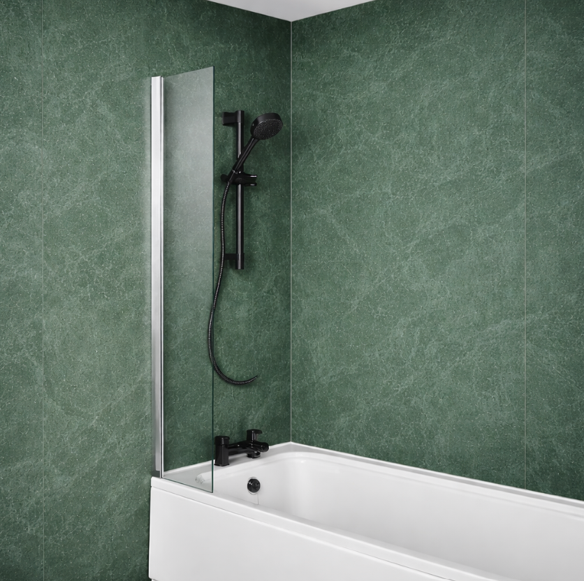 Modern bathroom with green tiled walls, black shower set and taps, white bathtub and clear glass bath screen with chrome wall profile