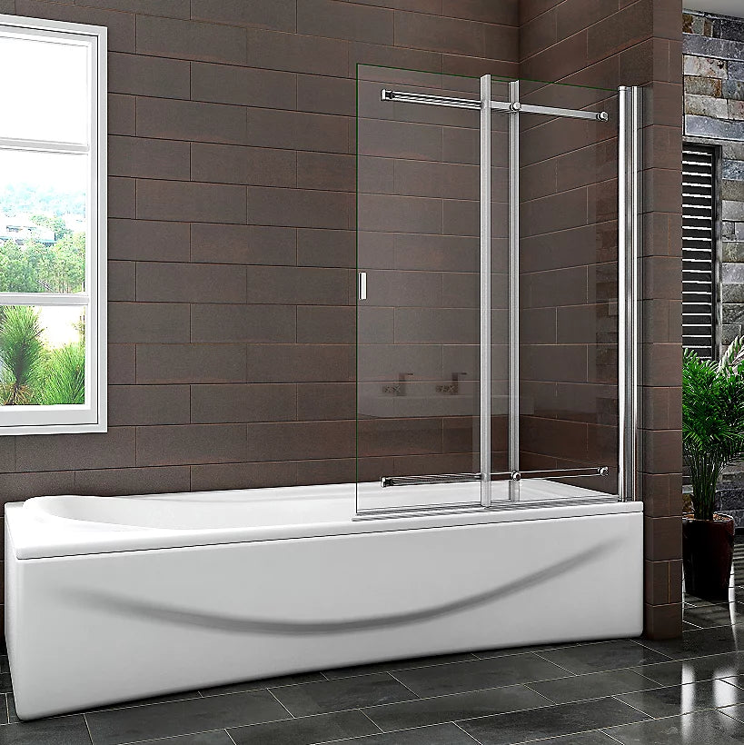 Bathroom with a white bathtub and glass shower enclosure against a brown tiled wall.