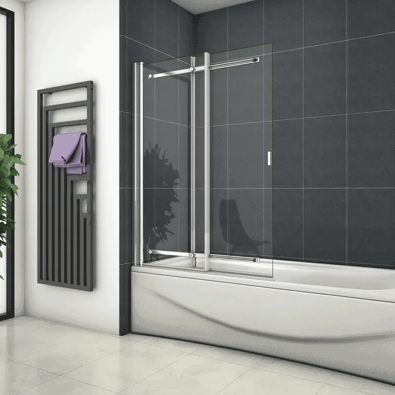 Chrome Sliding Pivot Bath Shower Screen With Clear Glass Installed Over Bath In Modern Dark Tiled Bathroom With Towel Radiator