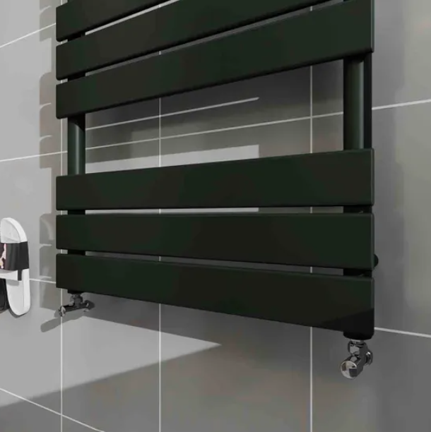 Close up of black flat panel heated towel rail radiator in modern grey tiled bathroom setting.