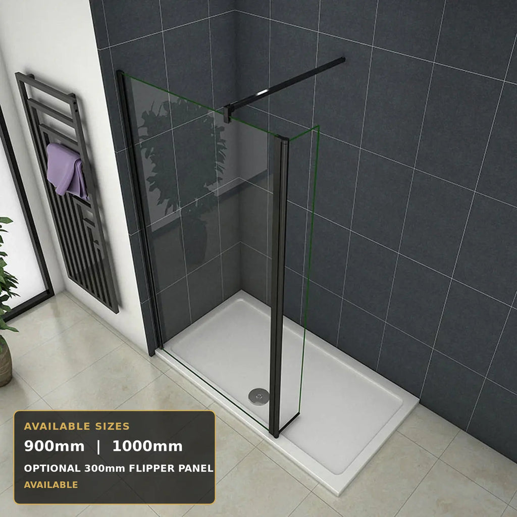 A modern shower enclosure with a clear glass front panel, black metal frame and rail, and a white rectangular shower base, shown installed in a tiled bathroom. A text overlay in the bottom left lists available sizes: 900mm, 1000mm, and optional 300mm flipper panel.