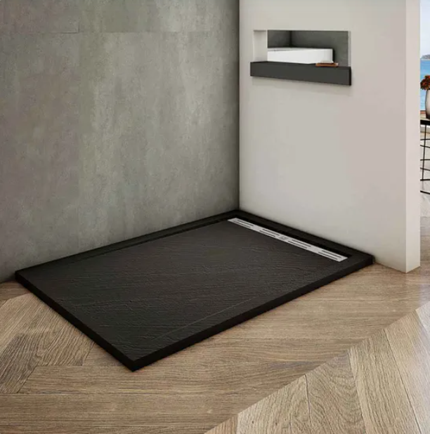 Rectangular black slate effect shower tray installed on bathroom floor with wood finish