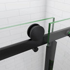 Black sliding shower door with glass panel on a white tiled wall background