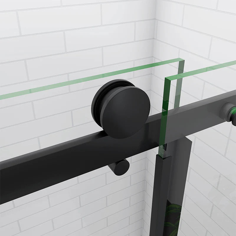 Black sliding shower door with glass panel on a white tiled wall background