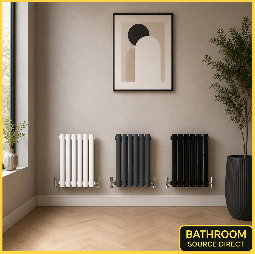 Three radiators of different designs on a wall with a plant and framed art above them, featuring 'Bathroom Source Direct' branding.