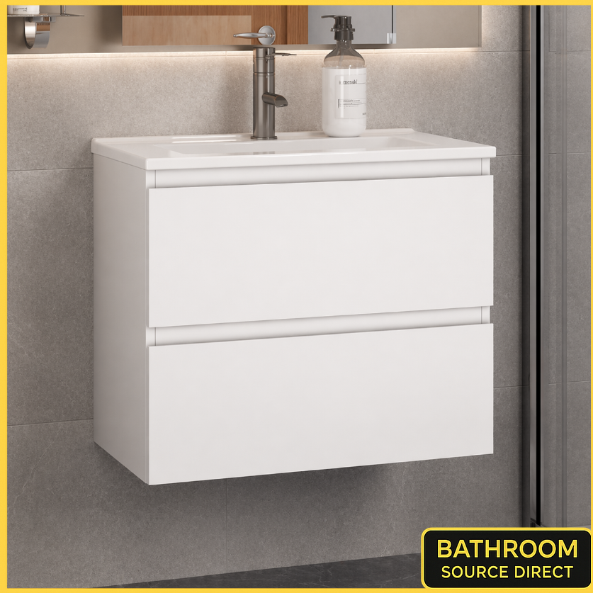 White bathroom vanity with sink and soap dispenser on a tiled wall.