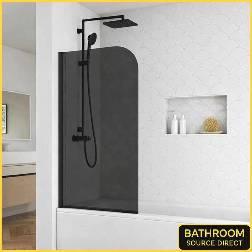 Matt black bath shower screen with smoked glass fitted over a white bath in a modern bathroom with wall niche and rainfall shower