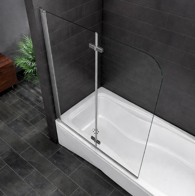 Curved chrome pivot bath screen over white bath with dark grey tiled walls viewed from above modern bathroom setting