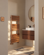 K-Rad Malibu brushed bronze towel rail displayed beside a walnut vanity unit