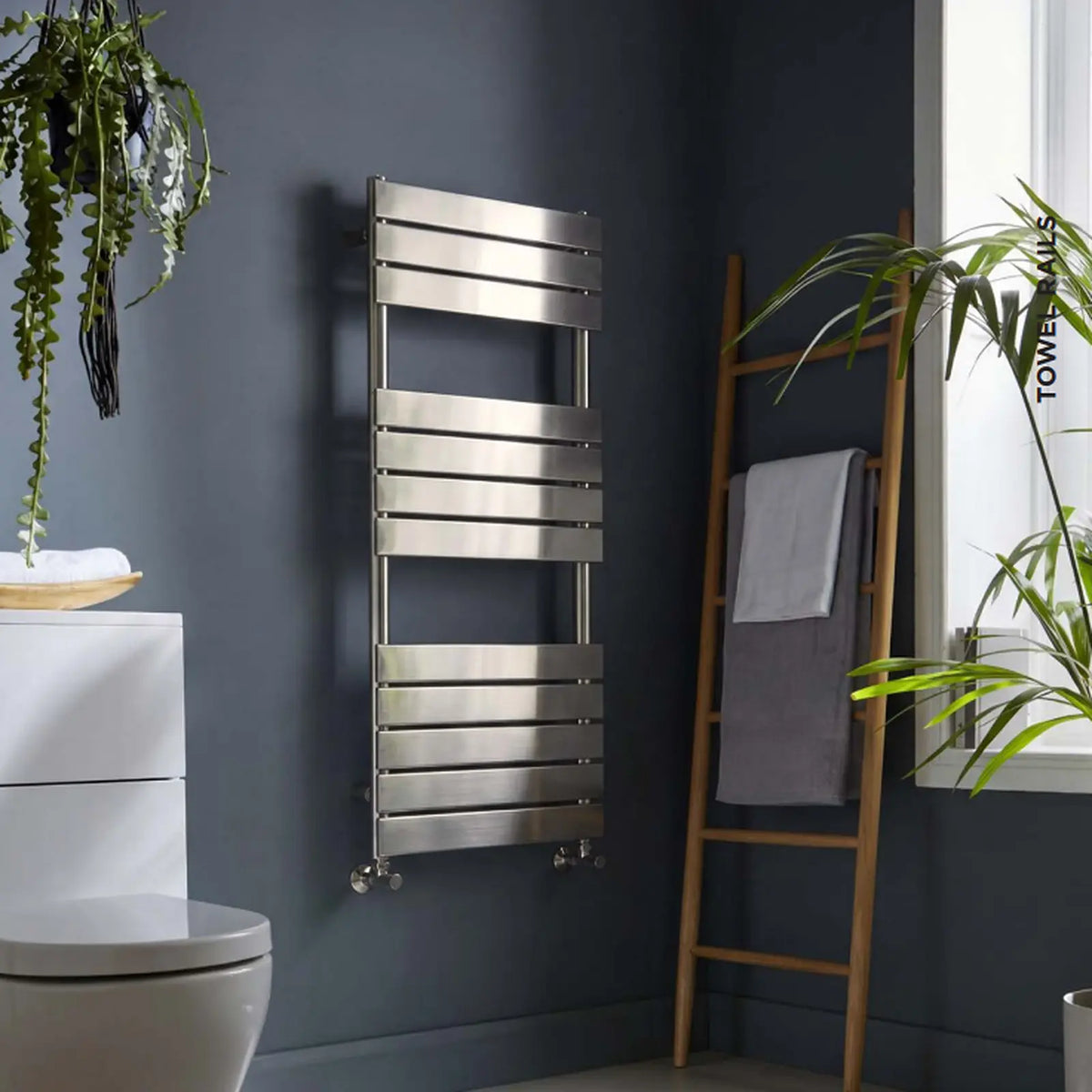 K-Rad Malibu brushed nickel designer towel rail on a dark bathroom wall