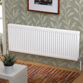 K Rad Type 21 white central heating radiator, 1600mm wide, wall mounted against modern sage green botanical wallpaper with wooden flooring.