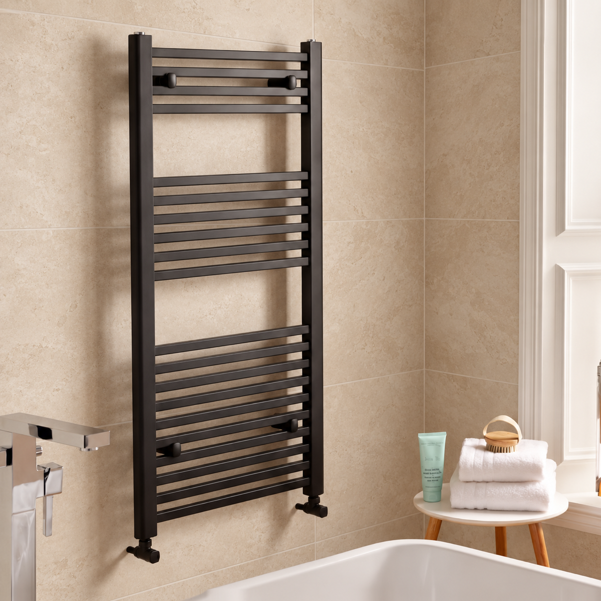 K Warm square matt black towel rail in a warm stone tiled bathroom