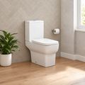 White Kavara Korsika close coupled toilet with soft close seat in a herringbone tiled bathroom