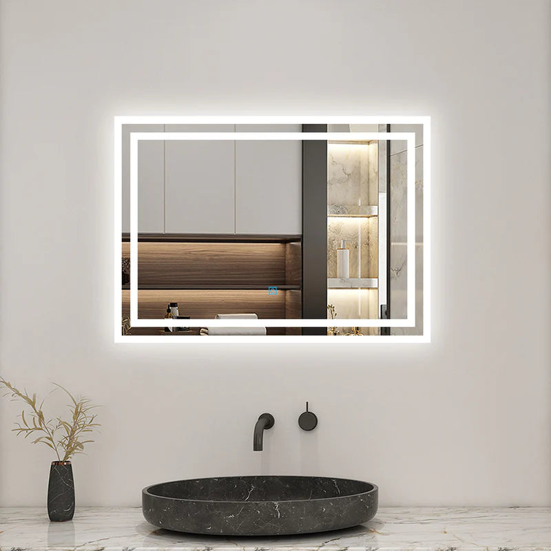 Frameless backlit LED bathroom mirror installed above black stone basin