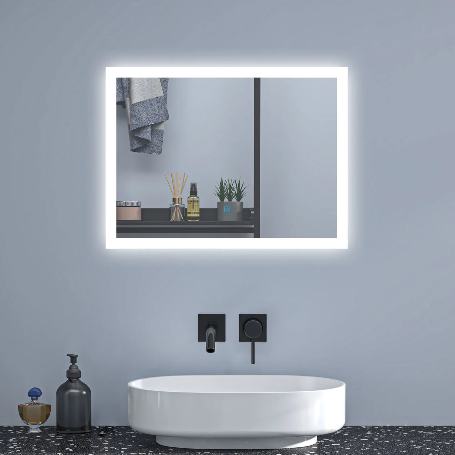 Rectangular backlit LED bathroom mirror installed above countertop basin