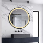 Black-framed round LED bathroom mirror illuminated in warm white above a basin