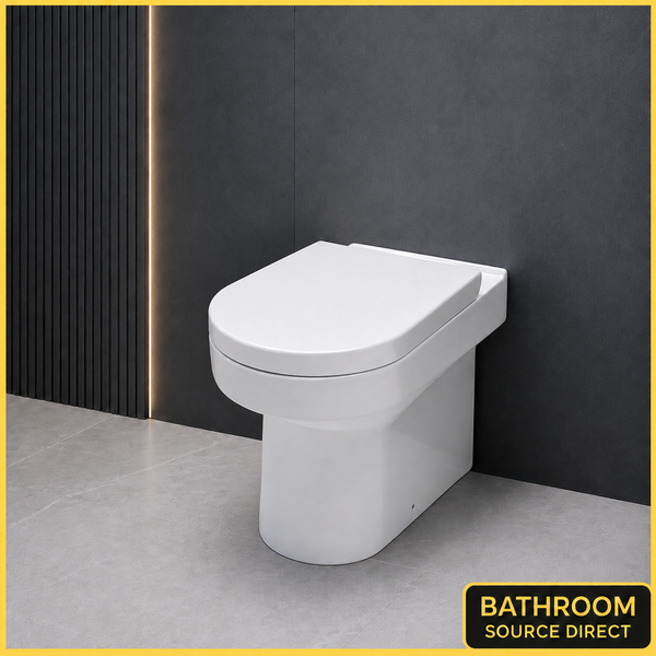 Oakham D shape back to wall toilet with soft close seat against a dark feature wall