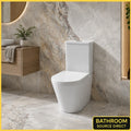Oakham round rimless close coupled toilet with soft close seat in a marble tiled bathroom