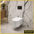 Oakham rimless wall hung toilet in a marble tiled bathroom with black flush plate