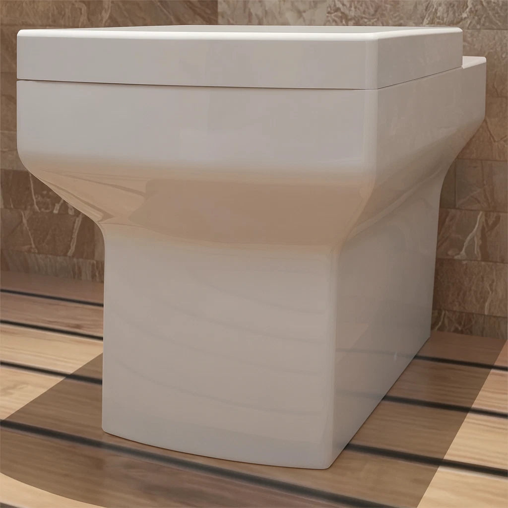 White ceramic sink on a wooden floor with a tiled wall background