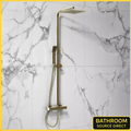 Scudo Elliot square thermostatic shower riser kit in brushed brass with marble wall background