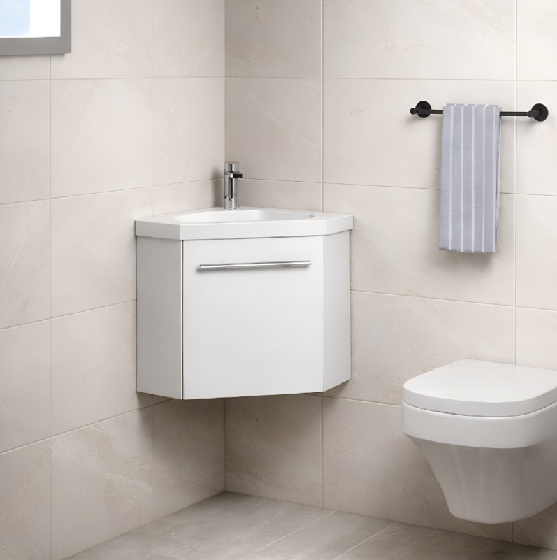 Sila matt white 400mm corner cloakroom vanity unit with resin basin wall hung bathroom unit in light tile bathroom setting with matching toilet