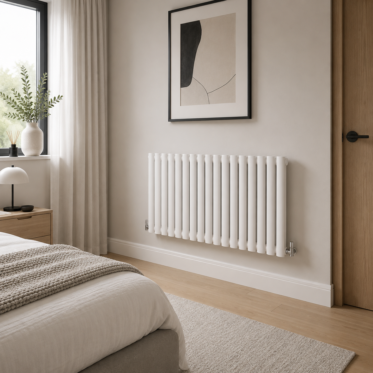 White horizontal oval column radiator in modern bedroom setting 600 x 1003mm