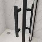 Close up of the twin matt black bar handles on the Vitrano double bi fold shower enclosure