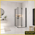 Vitrano matt black double bi fold square shower enclosure with 6mm NANO glass in a modern Carrara marble bathroom