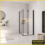 Vitrano matt black double bi fold square shower enclosure with 6mm NANO glass in a modern Carrara marble bathroom