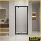Vitrano matt black pivot shower door with 6mm easy clean glass in a modern Carrara marble bathroom