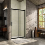 Vitrano matt black sliding shower door with clear 8mm glass fitted across a bathroom recess