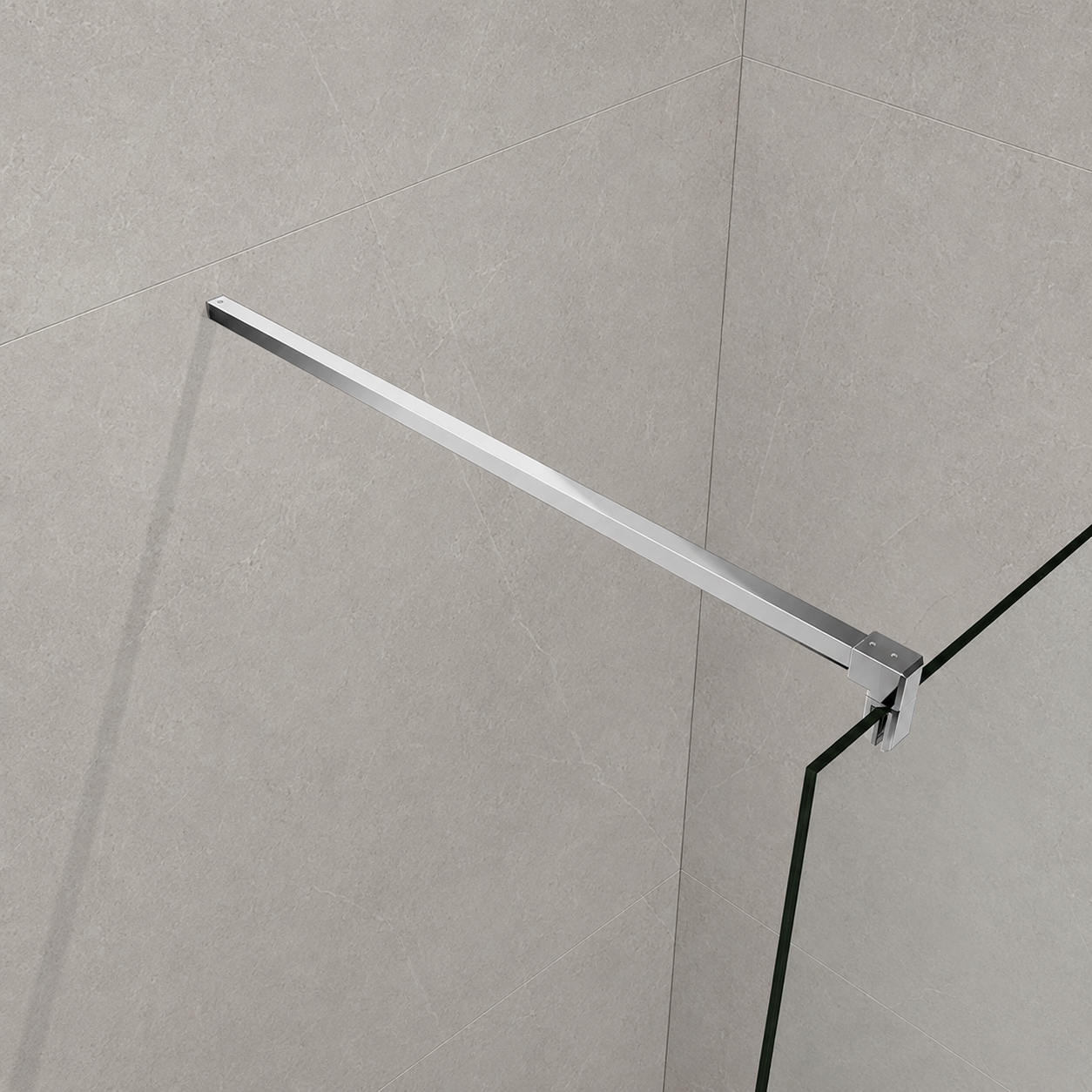 A modern chrome glass shower door handle mounted on a light gray tiled wall next to a glass panel.