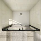Overhead view of the Vitrano matt black sliding shower door showing the recess installation and shower tray