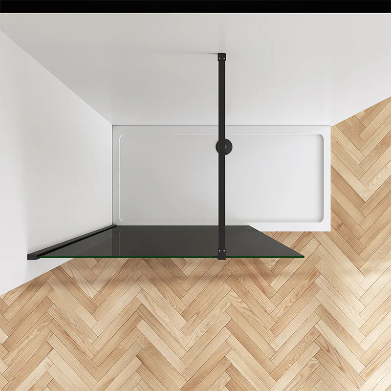 Top view of black walk in shower screen with tray and herringbone flooring